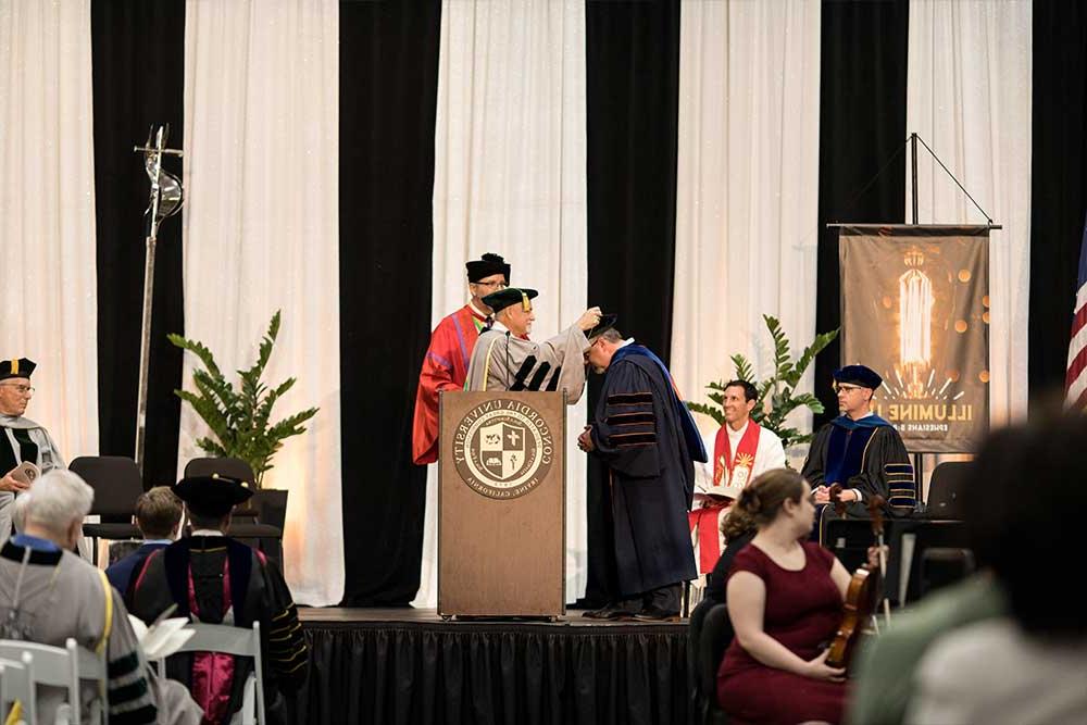 President Thomas being greeted at the podium