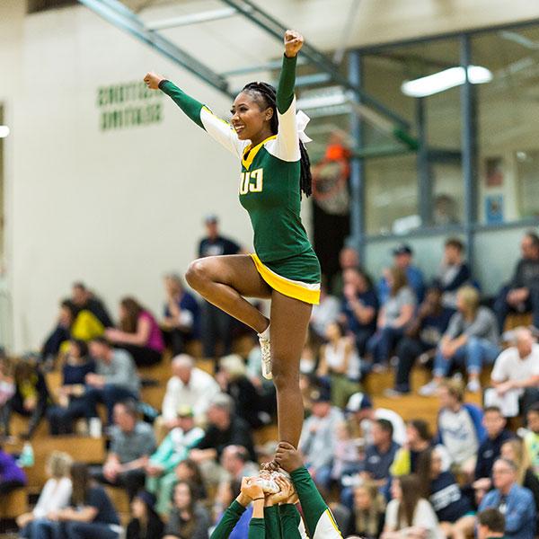 CUI cheer team performing at a game